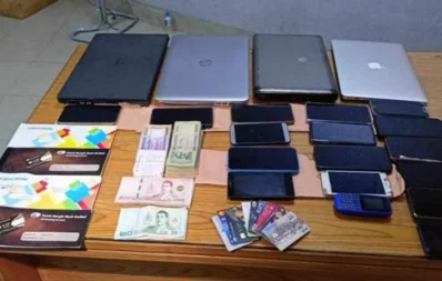 The CID seize 19 mobile phones, four laptops, various bank check books, bank cards, admission admit cards, cash amounting to Tk2.11 lakh, and 15,100 baht in Thai currency from the arrestees’ possession. Photo: Bangla Tribune