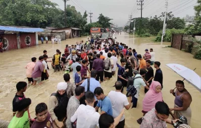 The photo shows people travelling in waterlogged roads caused by heavy rainfall in Chittagong on Sunday, August 27, 2023. Photo: Dhaka Tribune