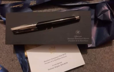 French President Emmanuel Macron presents pen to musician and lyricist Rahul Ananda of the singing group “Joler Gaan” at his private studio in the capital’s Dhanmondi house on Sunday, September 10, 2023. Photo: Courtesy