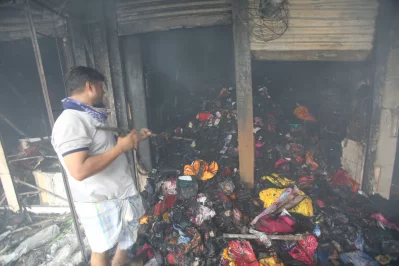 Photo shows a local trying to salvage products of his shop from the ashes as a massive fire broke out at Dhaka’s Mohammadpur Krishi Market on Thursday, September 14, 2023. Photo: Mehedi Hasan/Dhaka Tribune