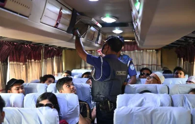 Police search a bus in the Aminbazar area ahead of the rallies scheduled for Saturday. Photo: Mehedi Hasan/Dhaka Tribune