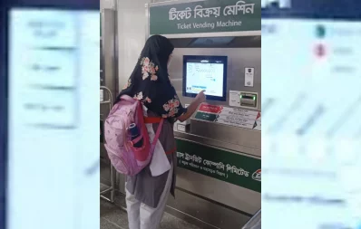 A school student is seen purchasing a ticket from a vending machine at Motijheel Metro Rail Station in Dhaka on Sunday, November 5, 2023. Photo: Dhaka Tribune