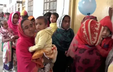 People wait in queue at the Rangpur Medical College Hospital’s outdoor area with children Monday, January 10, 2022 Dhaka Tribune