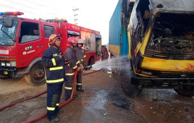 Firefighters work to douse a fire on a covered van in Gazipur on Thursday, November 30, 2023. Photo: UNB