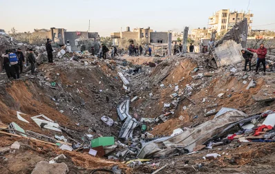 People search building rubble for items to salvage following an early morning Israeli strike in Rafah in the southern Gaza Strip on December 12, 2023. Photo: AFP