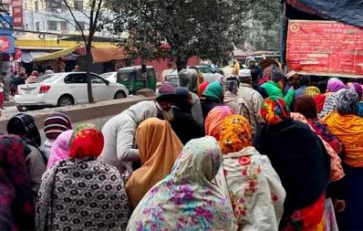 The image shows low-income people buying food products from a TCB truck in Dhaka ignoring the chilling weather. Photo: Bangla Tribune