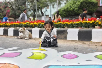 The image shows minor girl drawing an alpona on a road at Dhaka University campus on Tuesday, February 20, 2024, centring International Mother Language Day. Photo: Ahadul Karim Ahad/Dhaka Tribune