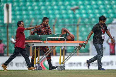 Mustafizur Rahman reacts as he leaves the field on a stretcher after suffering an injury Photo: AFP