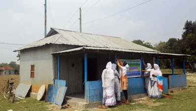In this picture taken on March 22, 2024, members of the hijra community hang a banner outside the Dakshin Char Kalibari Mosque for the Third Gender, in Mymensingh. Photo: AFP