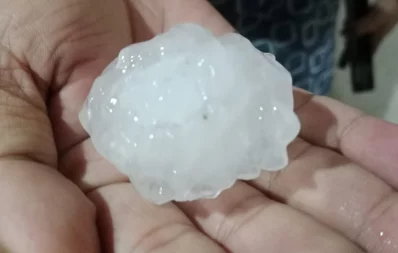 A man is seen holding a hailstone after a storm in Sylhet on Sunday, March 31, 2024. Photo: Dhaka Tribune