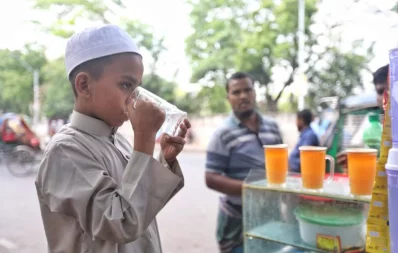 The image shows a boy drinking juice from a roadside shop in Dhaka to get relief from scorching heat. Photo: Ahadul Karim Khan/Dhaka Tribune