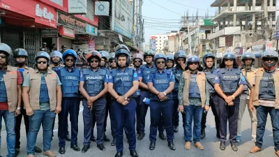 The image shows law enforcers in an alert position in Faridpur on Friday, centring a protest rally, April 26, 2024. Photo: Dhaka Tribune