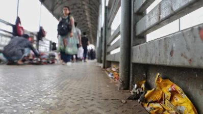 People walk on an uncleaned overbridge in Dhaka`s Newmarket area on Thursday, May 16, 2024. Photo: Ahadul Karim Khan/Dhaka Tribune