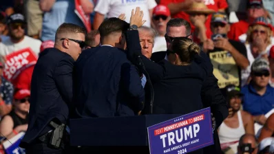 Republican presidential candidate, former US president Donald Trump is whisked away by Secret Service after shots rang out at a campaign rally at Butler Farm Show Inc on July 13, 2024 in Butler, Pennsylvania. Photo: AFP
