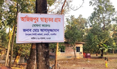 A Healthy Village signboard hanging on a tree in Satkhira. Photo: Nawaz Farhin Antara/ Dhaka Tribune