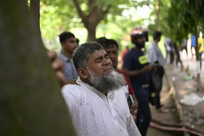 An emotional photo captures a father crying at the crash site following the F-7 training jet crash at Milestone School and College. Photo: Mahmud Hossain Opu/Dhaka Tribune