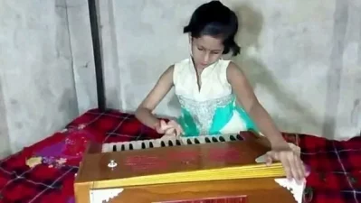 A child practices playing a harmonium. Photo: Dhaka Tribune