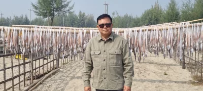 Writer standing in front of fish sun dried at Sonadia Island. Photo: Ziaur Rahman