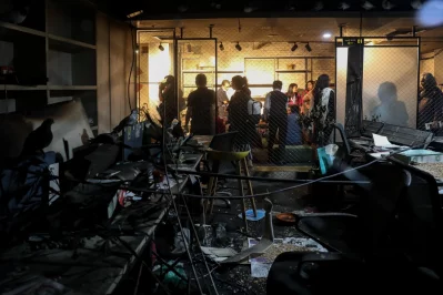 Visitors attend an exhibition at the offices of Prothom Alo in Dhaka, Bangladesh, February 18, 2026, displaying damage caused by vandalism on December 18, 2025.