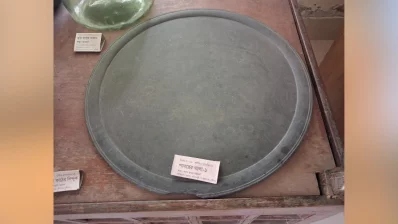 The object in the image is a – Patharer Thala (stone plate) – an ancient artifact on display in the museum. Stone plates and other stone objects like pillars and pestles have a long history in Bengal, particularly during the medieval period (14th–15th centuries). Photo: Dhaka Tribune