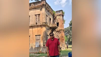 The writer standing in front of one of the buildings inside the Bhagyakul Zamindari estate. It is a two-story structure known for its symmetrical design, where doors and windows are the same size. It also features eight massive pillars at the front, reminiscent of grand classical styles. While once a symbol of immense wealth, much of the estate is now in a dilapidated or ruined state due to time and neglect. Photo: Dhaka Tribune