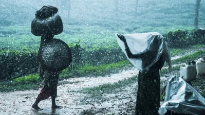 Women move through heavy rain in a climate-vulnerable rural area, where extreme weather is not an abstract threat but a daily reality that shapes work, mobility, and survival. Photo: Kingshuk Partha/ICCCAD, IUB