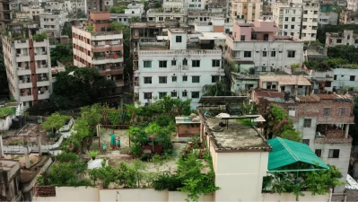 A mother spends time with children on a rooftop garden in Dhaka, where small urban green spaces reflect women’s everyday role in shaping more livable and climate-conscious city life. Photo: Kingshuk Partha/ICCCAD, IUB