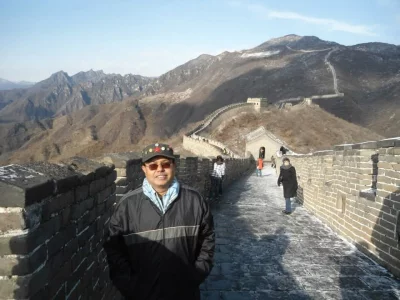 The image captures the Great Wall at Mutianyu snaking along mountain ridges, which is characteristic of the rugged terrain in this region.