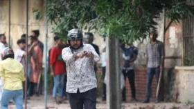Who is the gunman spotted during clashes at DU?