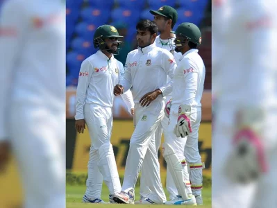 Bangladeshs Mehidi Hasan Miraj celebrates with teammates after the dismissal of Indias Cheteshwar Pujara during the first day of the Test cricket match between India and Bangladesh at The Rajiv Gandhi International Cricket Stadium in Hyderabad on February 9, 2017AFP