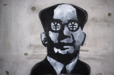 Graffiti depicting a portrait of former Chinese leader Mao Zedong with Chinese yuan signs in his eyes is seen on a wall in Shanghai on March 1, 2017rnrnAFP