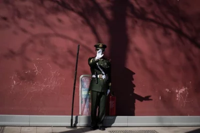 A paramilitary guard gestures not to be photographed at the gate of the Forbidden City ahead of upcoming opening sessions of the Chinese Peoples Political Consultative Conference (CPPCC) and the National Peoples Congress (NPC) in Beijing on March 1, 2017rnrnAFP