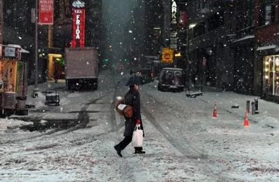 People walk the snow and sleet-covered streets of New York on March 14, 2017. Winter Storm Stella unleashed its fury on much of the northeastern US on March 14 dropping snow and sleet across the region and leading to school closures and thousands of flight cancellations. Stella, the most powerful winter storm of the season, was forecast to dump up to two feet of snow in New York and whip the area with combined with winds of up to 60 miles per hour, causing treacherous whiteout conditions. But after daybreak the National Weather Service (NWS) revised down its predicted snow accumulation for the city of New York, saying that the storm had moved across the coastrnrnAFP