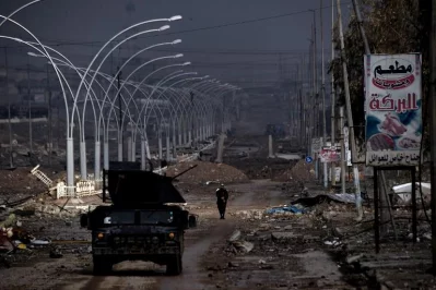 A man walks along a damaged avenue in west Mosul on March 14, 2017, as the Iraqi forces continue to advance in the embattled city combatting Islamic State (IS) group fighters.rnBaghdads forces launched a major drive last month to oust the Islamic State group from west Mosul, a battle that has pushed more than 80,000 people to flee their homes in less than three weeksrnrnAFP