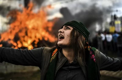 A Kurdish woman dances in front of a fire as Turkish Kurds gather for Newroz celebrations for the new year in Diyarbakir, southeastern Turkey, on March 21, 2017. rnNewroz is an ancient Persian festival, which is also celebrated by Kurdish people, marking the first day of spring, which falls on March 21rnrnAFP