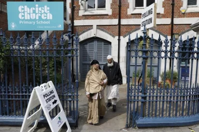 People are pictured outside a polling station on Brick Lane, east London on June 8, 2017, as Britain holds a general electionrnAFP