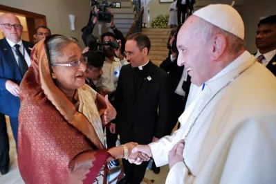 This handout picture taken and released by the Vatican press office (Osservatore Romano) on December 1, 2017 shows Pope Francis shaking hands with Prime Minister of Bangladesh Sheikh Hasina during their meeting in Dhaka | AFP PHOTO / OSSERVATORE ROMANO