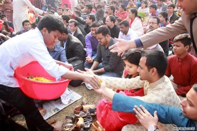Devotees receiving Prasad (food offered at Hindu religious festivals) after the Puja at Dhaka Universityu2019s Jagannath Hall on Monday | Focus Bangla