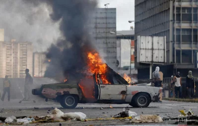 A car is engulfed in flames, set on fire by anti-government demonstrations during clashes with National Guards in Caracas, Venezuela, Thursday, July 20, 2017. Venezuelan President Nicolas Maduro and his opponents faced a crucial showdown Thursday as the countrys opposition called for a 24-hour national strikernAP