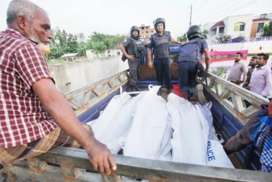 Policemen are seen driving off in a mini truck with bodies of suspected militants DHAKA TRIBUNE/RAJIB DHAR