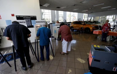 People vote at a Ford dealership during the primary election in Montebello, California. Photo: Mario Anzuoni