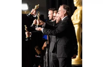 Film editor John Gilbert (C), winner of the award for Editing for Hacksaw Ridge, poses with presenters Michael J. Fox (L) and Seth Rogen in the press room during the 89th Annual Academy Awards at Hollywood &amp; Highland Centre on February 26, 2017 in Hollywood, California/AFP