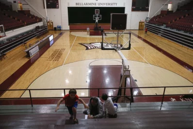 A man votes with children inside a gym at the Bellarmine University polling station in Louisville, Kentucky. Photo: Shannon Stapleton