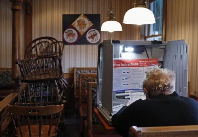 A voter prepares to cast her ballot at a restaurant used as a polling station in Chicago. Photo: Jim Young