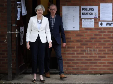 PM Theresa May arrives with her husband Philip to vote in Sonning, Britain June 8, 2017rnREUTERS