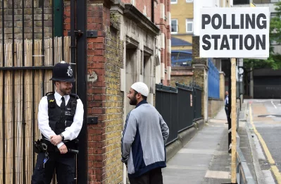 A police officer stands on duty outside a polling station in Tower Hamlets, London, Britain June 8, 2017rnREUTERS