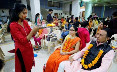 A girl offers prayer to her parents during an event called Matru-Pitru Puja, Parents Worship, inside a temple to celebrate the New Year in Ahmedabad, India, December 31, 2017 Reuters