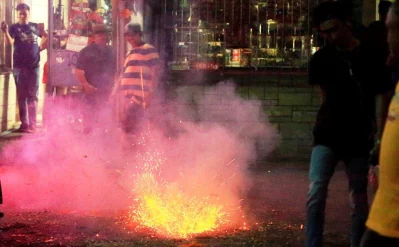 Residents watch firecrackers exploding to welcome 2018 during New Year Eve celebrations in Paranaque city, metro Manila, Philippines December 31, 2017 Reuters