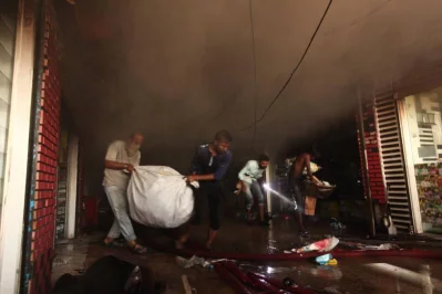 Firefighters seen trying to douse the fire as bystanders look on RAJIB DHAR/DHAKA TRIBUNE