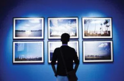 A visitor on the last day of the art summit taking in all the exhibitions on display on Saturday | Mehedi Hasan/Dhaka Tribune